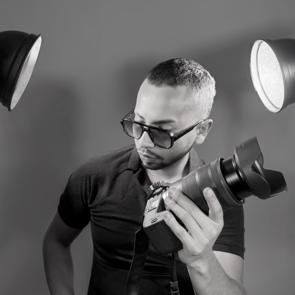 Alejandro of Sarlen Studios reviewing his camera between studio lights